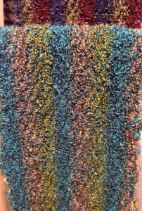 This warm, fuzzy scarf is woven of Acrylic.  A man-made fiber.